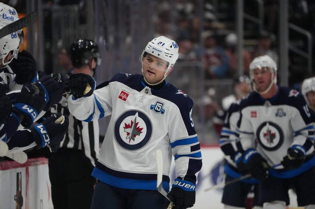 Winnipeg Jets center Cole Perfetti (91) in the third period of an NHL hockey game Saturday, March 28, 2026, in Denver. (AP Photo/David Zalubowski).