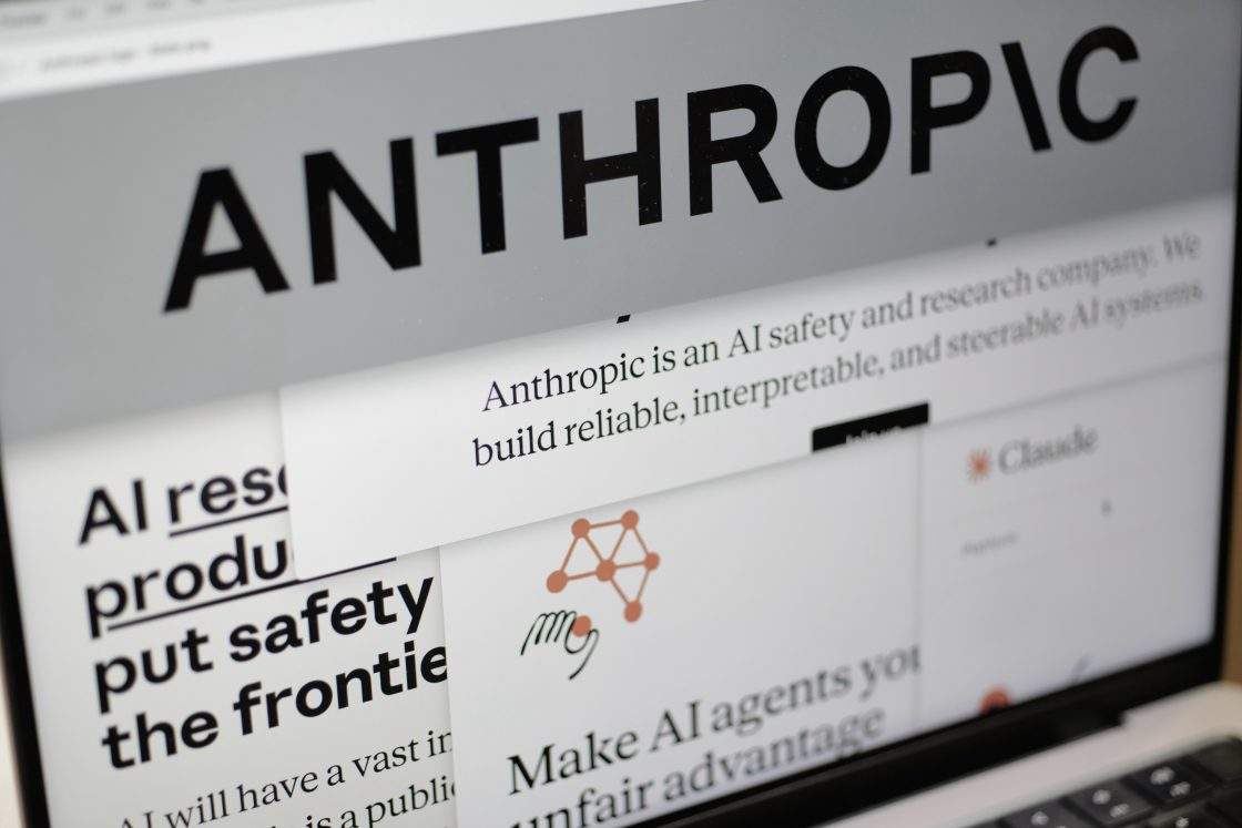 FILE - Pages from the Anthropic website and the company's logo are displayed on a computer screen in New York, Feb. 26, 2026. A group of economists are warning that action must be taken on AI before there are severe economic impacts.