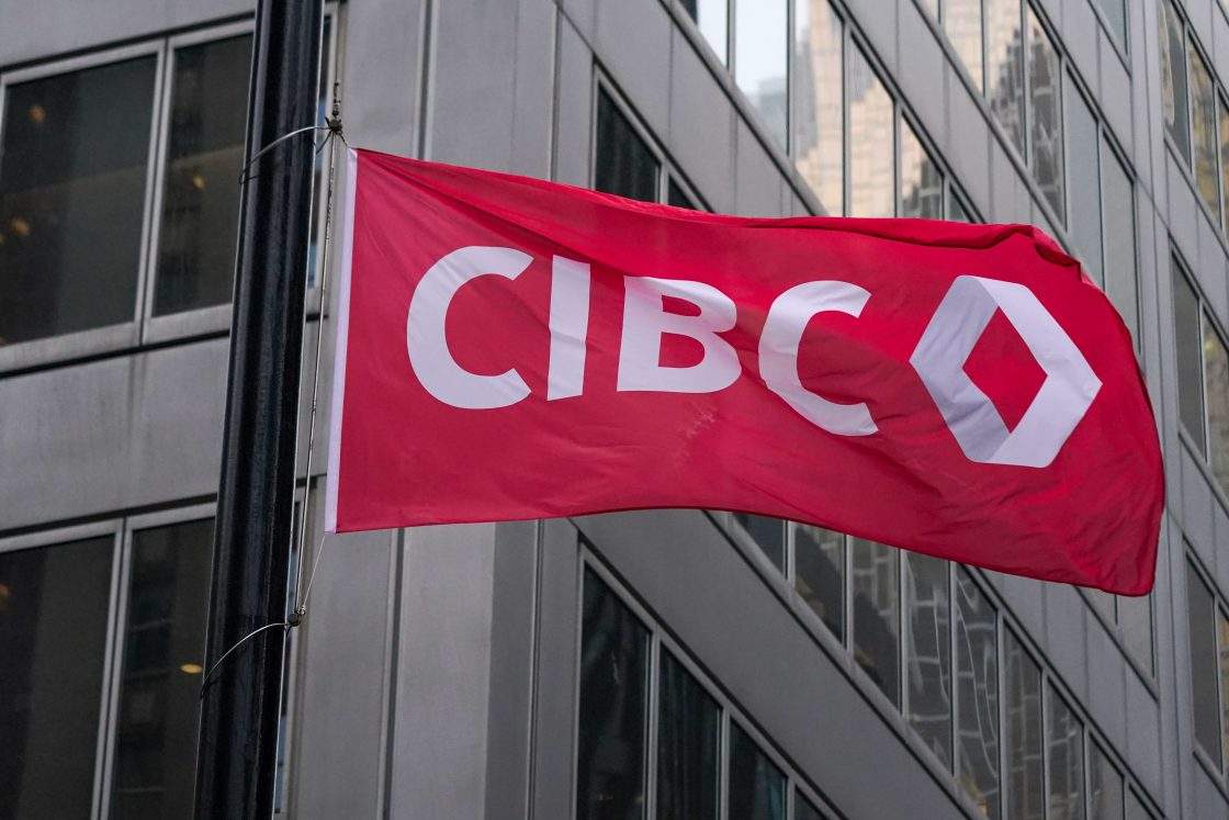 FILE - The CIBC logo displayed on a flag in front of its headquarters in Toronto on Oct. 25, 2021. The bank has agreed to a proposed class action focused on NSF fees.
