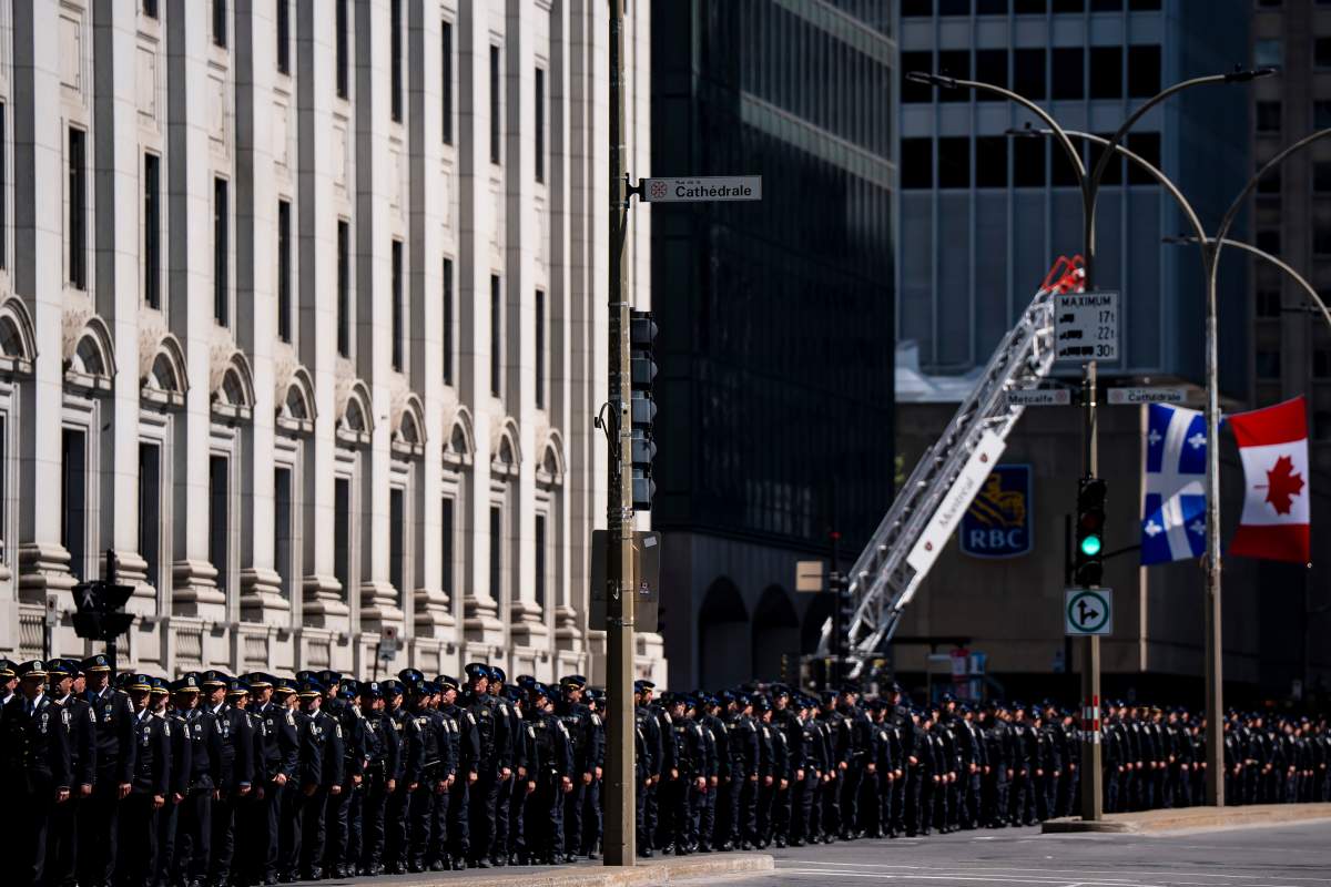 Montreal police officers take part in a procession in honour of fallen officer Mohamed Lamine Benredouane in Montreal on Tuesday, July 7, 2026.