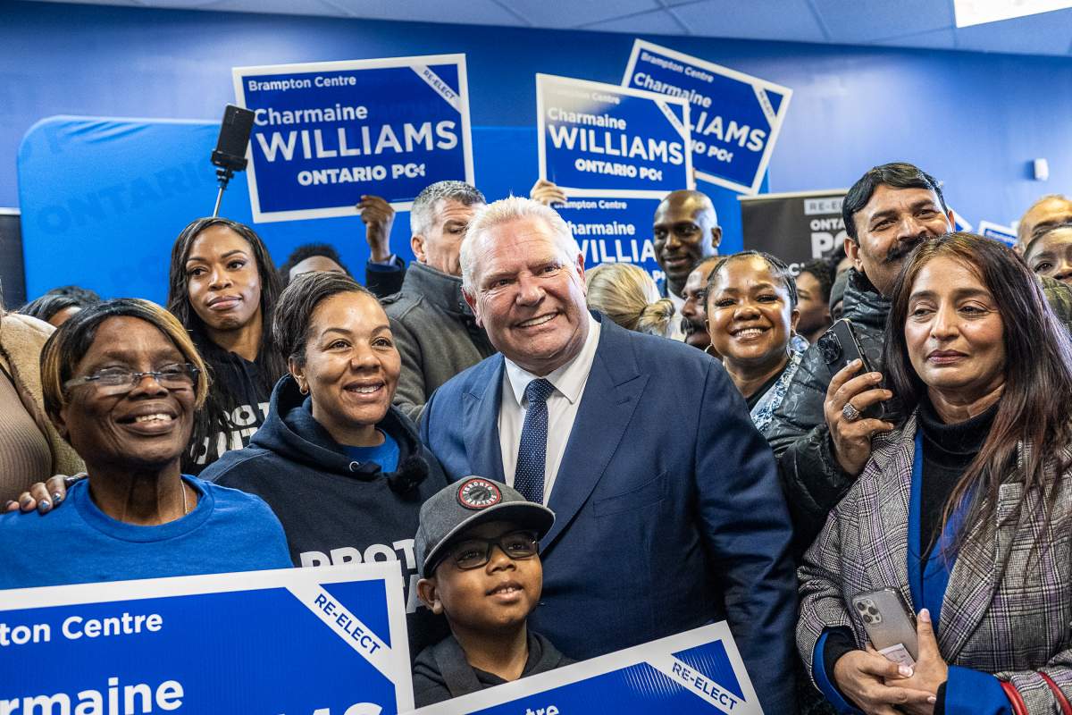 Ontario Premier Doug Ford attends the campaign office opening for Charmaine Williams, left, PC candidate for Brampton Centre, in Brampton on Feb. 1, 2025.