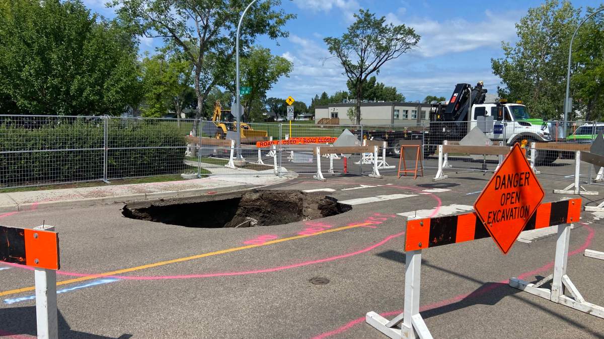 A deep sinkhole near 130 Avenue and 107 Street in north Edmonton’s Lauderdale neighbourhood on Monday, July 13, 2026.