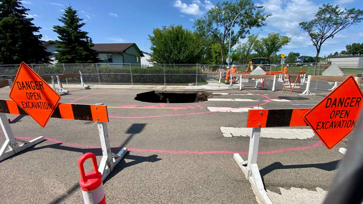 A deep sinkhole near 130 Avenue and 107 Street in north Edmonton’s Lauderdale neighbourhood on Monday, July 13, 2026.