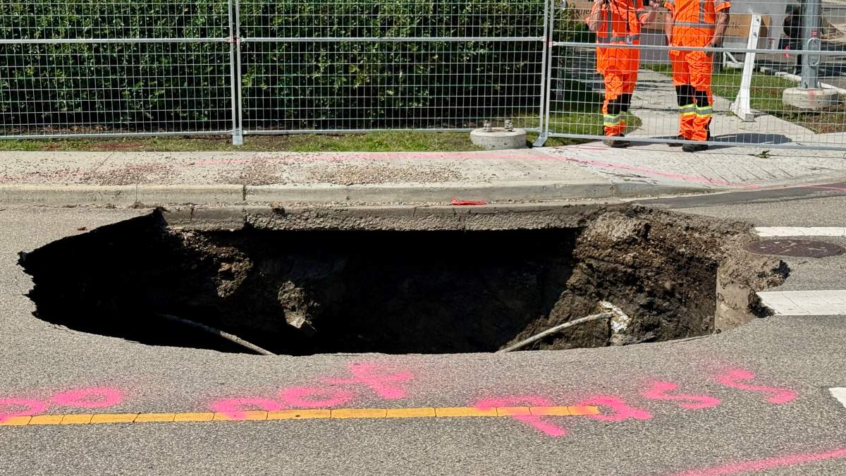 A deep sinkhole near 130 Avenue and 107 Street in north Edmonton’s Lauderdale neighbourhood on Monday, July 13, 2026.