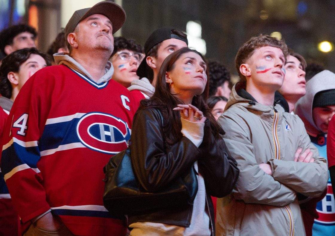 FILE - Montreal Canadiens fans watch their team on a video screen outside the Bell Centre take on the Tampa Bay Lightning in NHL playoff hockey action in Montreal on Friday, May 1, 2026.
