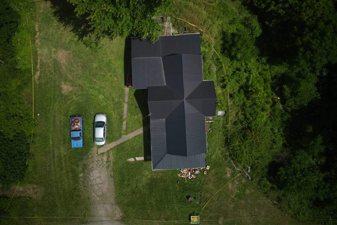 Police tape surrounds a home where authorities say they removed 16 children and arrested four adults in Hamden, Ohio, July 1, 2026.