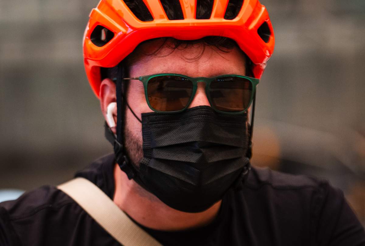 A cyclist wears a mask as wildfire smoke fills Toronto, on Wednesday, July 15, 2026. THE CANADIAN PRESS/Laura Proctor
