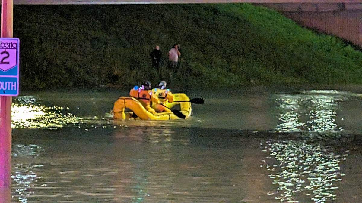 Firefighters rescuing stranded people after Whitemud Drive flooded under the 170 Street overpass in west Edmonton on Saturday, July 25, 2026.