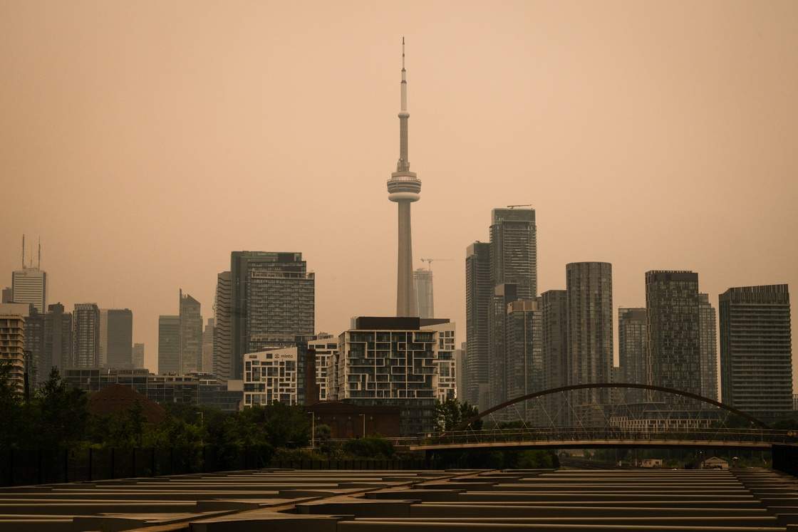 The CN Tower is pictured in Toronto as wildfire smoke fills the city, on Wednesday, July 15, 2026. THE CANADIAN PRESS/Laura Proctor