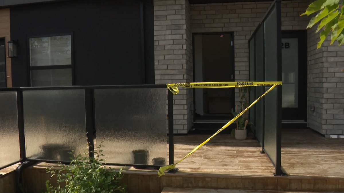 Police tape surrounds the entrance to a townhouse in the northwest Calgary community of Capitol Hill after a man was sent to hospital in life-threatening condition after being assaulted early Thursday morning.