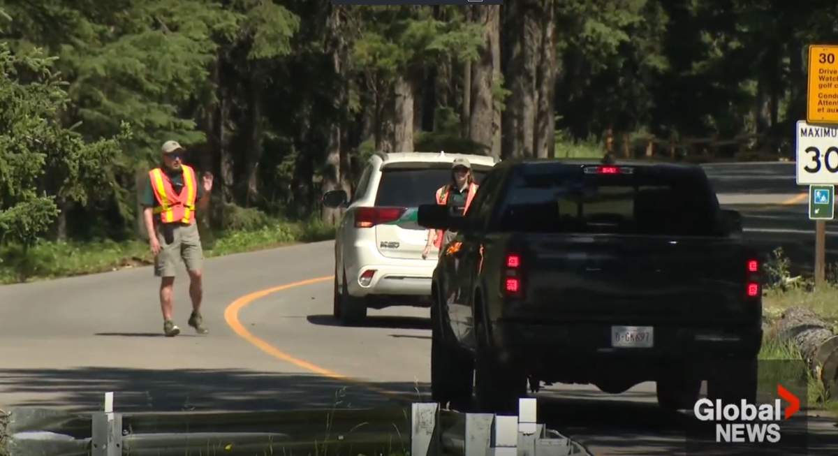 Parks Canada staff could be seen stopping traffic on Tuesday near the Spray River Bridge to prevent anyone from entering the area near where the rockslide happened.