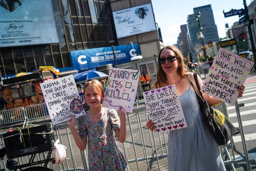Taylor Swift fans hold signs outside of Madison Square Garden ahead of a reported wedding between singer Taylor Swift and National Football League player Travis Kelce on Friday, July 3, 2026, in New York.