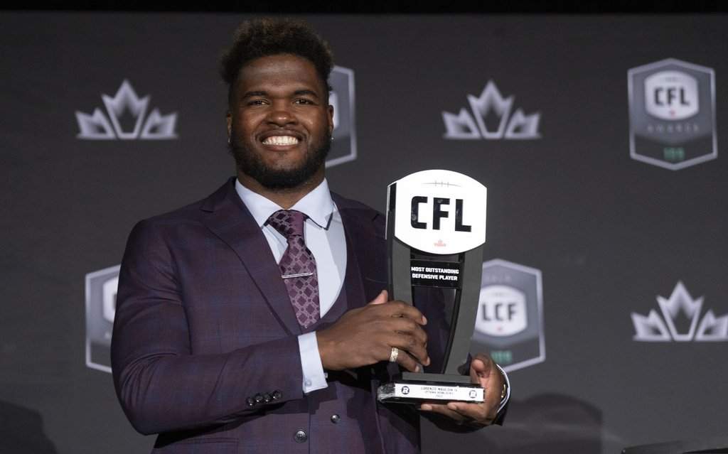 Most outstanding defensive player, defensive Linesman Lorenzo Mauldin IV of the Ottawa Red Blacks, holds up his trophy during the CFL Awards in Regina, Thursday, Nov. 17, 2022. THE CANADIAN PRESS/Paul Chiasson.
