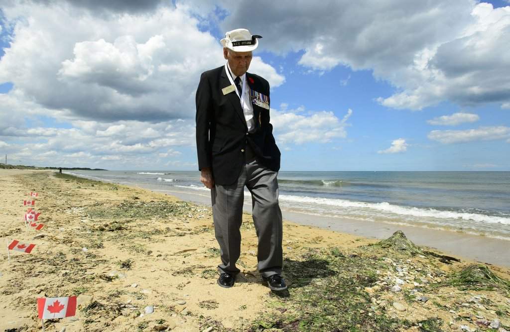 Veteran of the Second World War Bill Wilson walks on Juno Beach after the D-Day 75th Anniversary Canadian National Commemorative Ceremony at Juno Beach in Courseulles-sur-Mer, France, on Thursday, June 6, 2019.