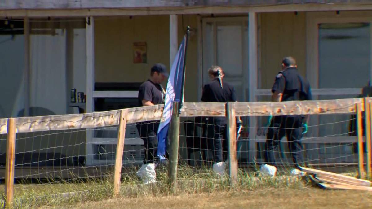 Investigators, dressed in protective gear, appeared to be looking for evidence both inside and outside the home, Wednesday morning.