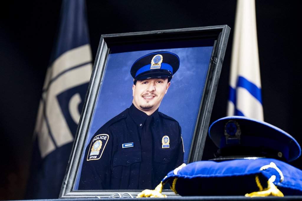 A portrait of fallen Montreal police officer Mohamed Lamine Benredouane is seen at his funeral ceremony in Montreal on Tuesday, July 7, 2026.