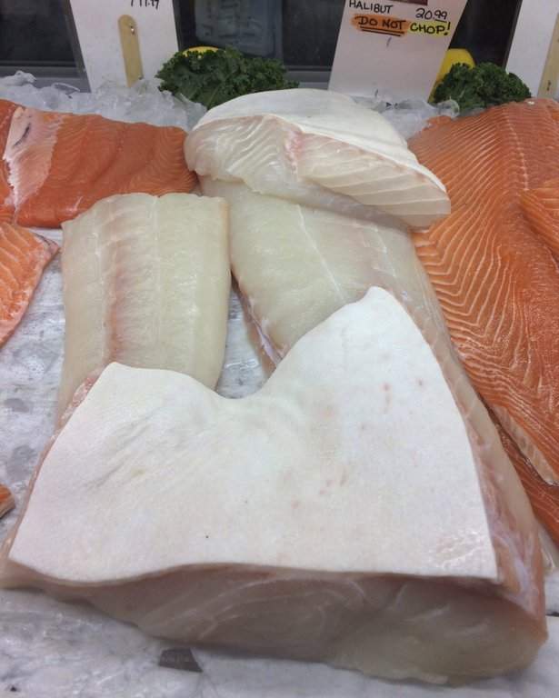 Atlantic halibut steaks are displayed for sale at a seafood market, Friday, Dec, 9, 2016, in Portland, Maine. THE CANADIAN PRESS/AP-Patrick Whittle.