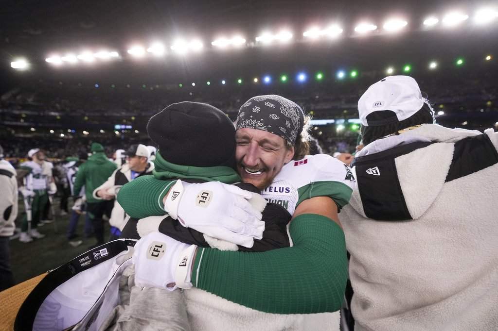 Saskatchewan Roughriders’ C.J. Avery (35), left, hugs teammate Jayden Dalke (38) as they celebrate their win over the Montreal Alouettes in the 112th CFL Grey Cup, in Winnipeg on Sunday, Nov. 16, 2025.