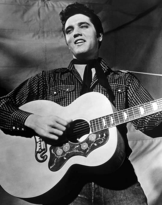 Elvis Presley is pictured in 1958. Despite multiple witnesses, a police presence, an autopsy, a coroner's investigation and an open-casket funeral, some conspiracy theorists insist Presley faked his own death in 1977.