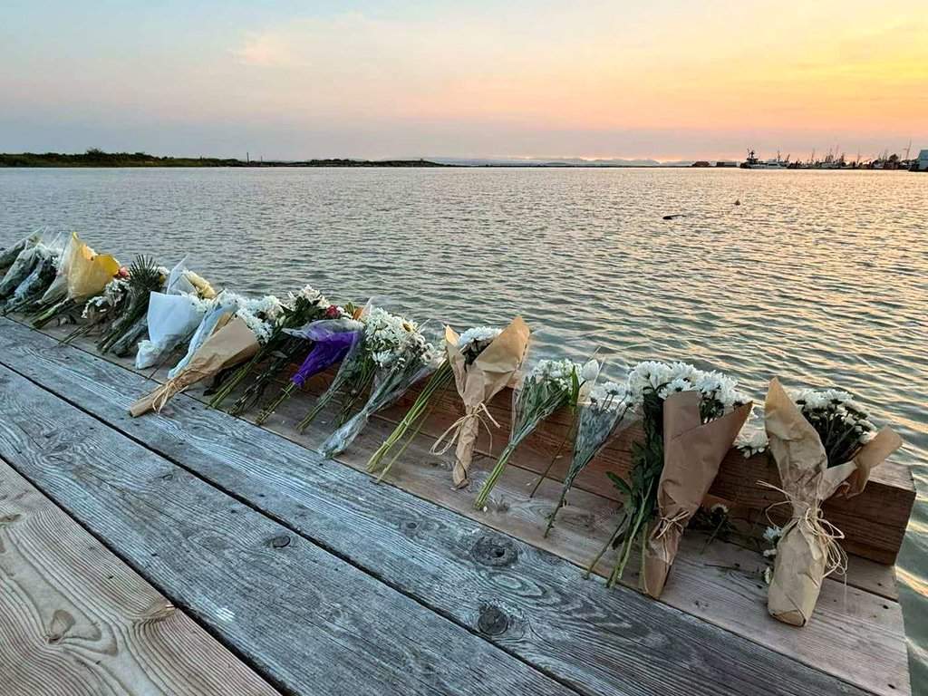 Flowers are seen placed alongside the Imperial Landing Dock in Richmond, B.C., to pay tribute to six people who are presumed drowned following the tragic capsizing of a commercial charter fishing boat in the Strait of Georgia on June 28, 2026.