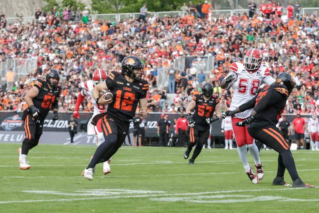 B.C. Lions quarterback Nathan Rourke (12) rushes for a first down against the Calgary Stampeders during first half CFL football action in Kelowna, B.C., on Saturday, June 27, 2026. THE CANADIAN PRESS/Steve Dunsmoor.