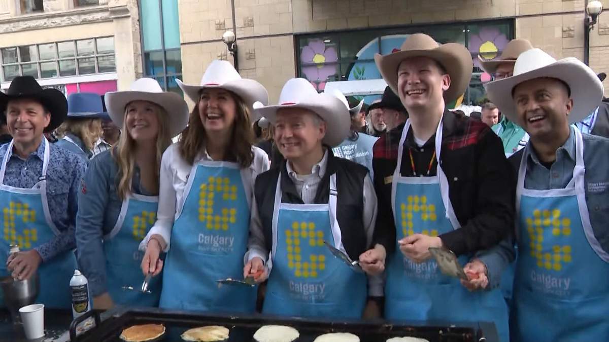 Alberta Premier Danielle Smith, Federal Finance Minister François-Philippe Champagne and Calgary Mayor Jeromy Farkas take part in the "first flip" on Thursday morning, marking the traditional kickoff to Calgary Stampede celebrations.