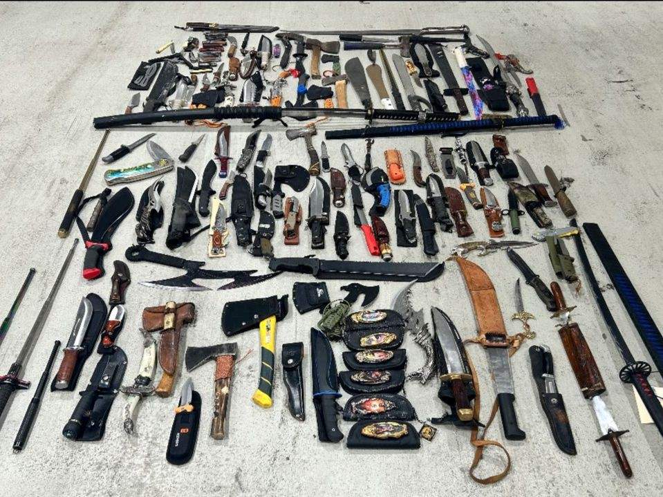 The dozens of sharp-edged weapons seized, include knives, axes, swords and even a set of Freddy Kruger-like claws.