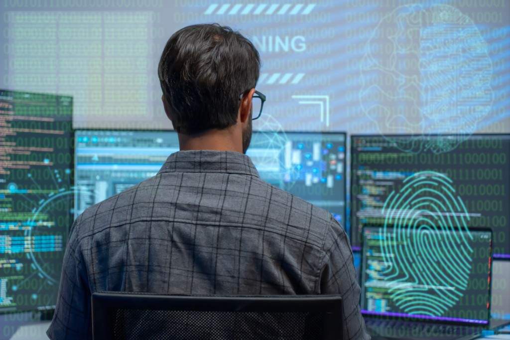 FILE - A computer attacker is seen using a computer with multiple screens in this photo from Sept. 16, 2025. A new report from IBM found the average cost of a data breach to Canadian organizations reached a record high.