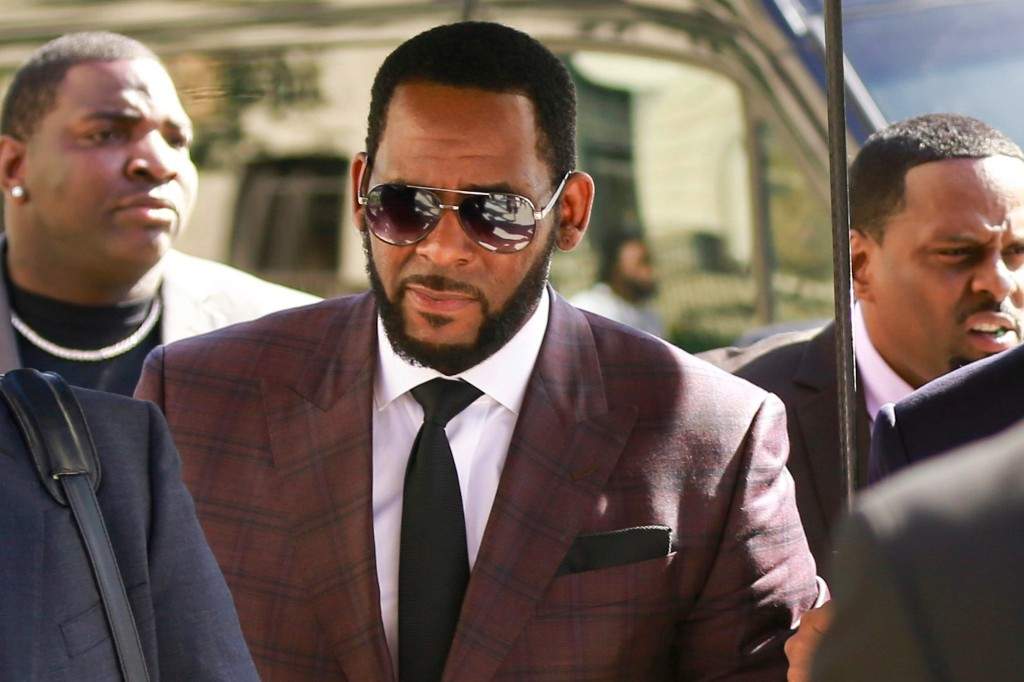 In this June 26, 2019 file photo, R&B singer R. Kelly, center, arrives at the Leighton Criminal Court building for an arraignment on sex-related felonies in Chicago.
