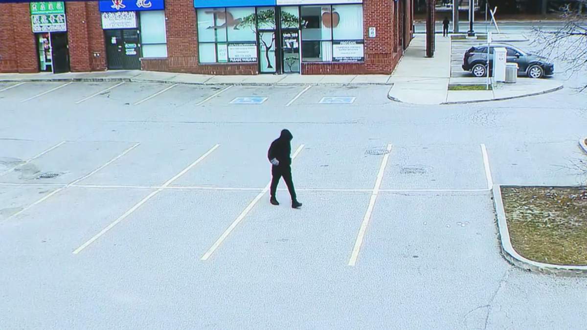 A still of a suspect in the 2022 Scarborough parking lot shooting death of Ding Ping Wang is shown. The still was taken from surveillance video police released showing the suspect on Nov. 11 walking the same path he took the day of Wang’s death on Nov. 12, 2022.