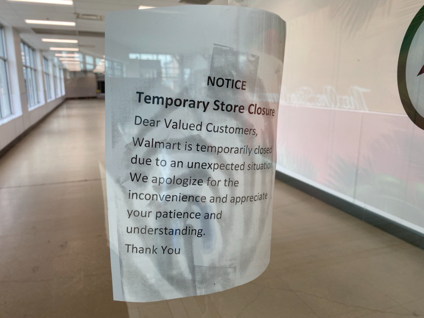A sign posted inside St. Vital Centre informs customers that its Walmart is temporarily closed.
