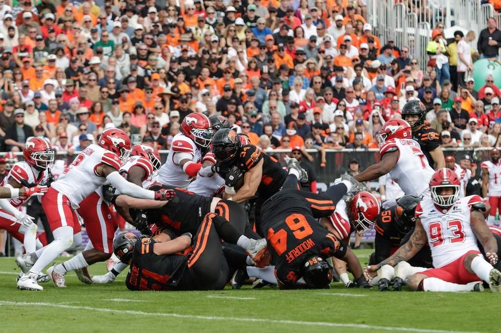 B.C. Lions' Zander Horvath (34) leaps through the pile to get a first down against the Calgary Stampeders during first half CFL football action in Kelowna, B.C., on Saturday, June 27, 2026. THE CANADIAN PRESS/Steve Dunsmoor.