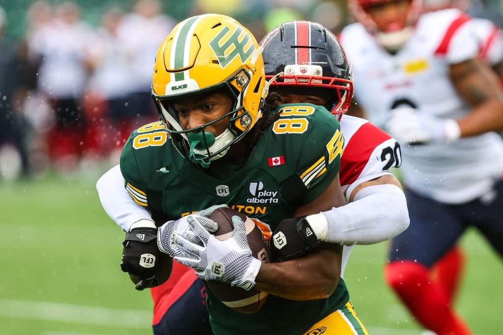 Edmonton Elks' TJ Luther (88) is tackled by Montreal Alouettes' Lorenzo Burns (20) during first half CFL football action in Edmonton on Saturday, June 20, 2026. THE CANADIAN PRESS/Codie McLachlan.