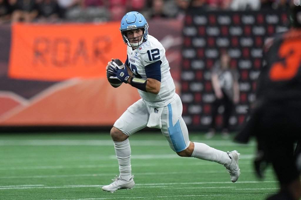 Toronto Argonauts quarterback Chad Kelly runs with the ball as he looks for a receiver during the first half of a CFL football game against the B.C. Lions in Vancouver, on Saturday, July 25, 2025. THE CANADIAN PRESS/Darryl Dyck.