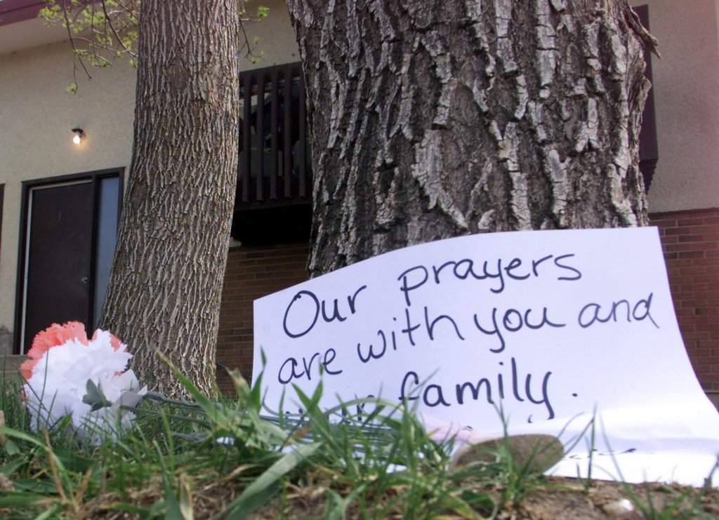 Flowers and a sign left by a well wisher outside the Koopmans home in Lethbridge, Alta. on Sunday May 13, 2001. 