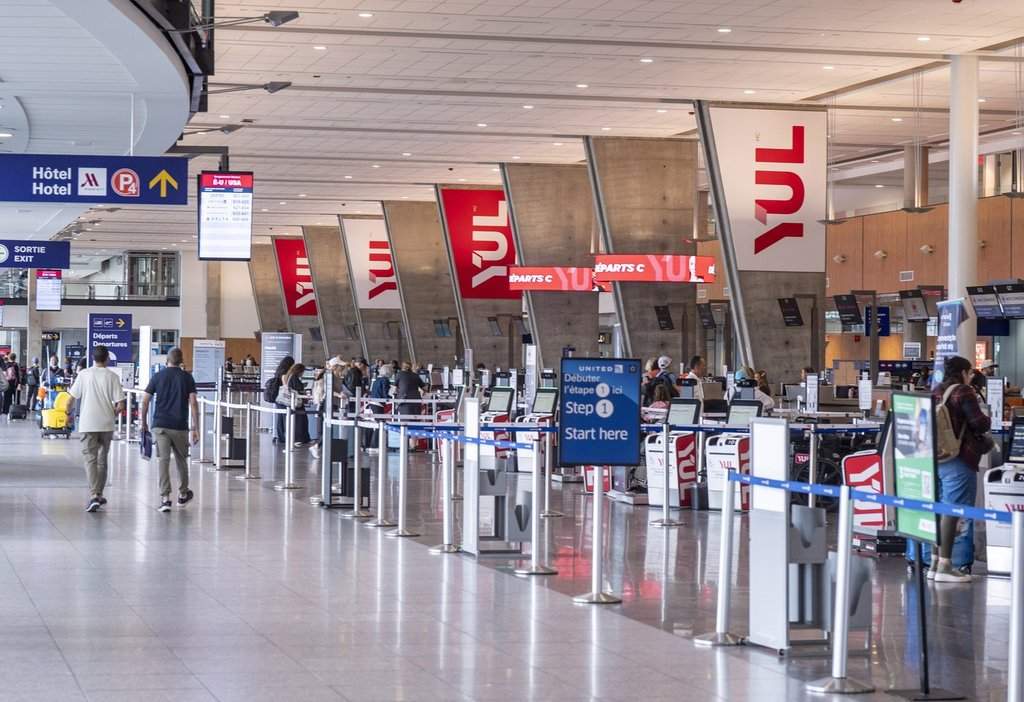 Travellers are seen at U.S. Departures at Montreal-Pierre Elliott Trudeau International Airport in Montreal on Wednesday, March 18, 2026. 
