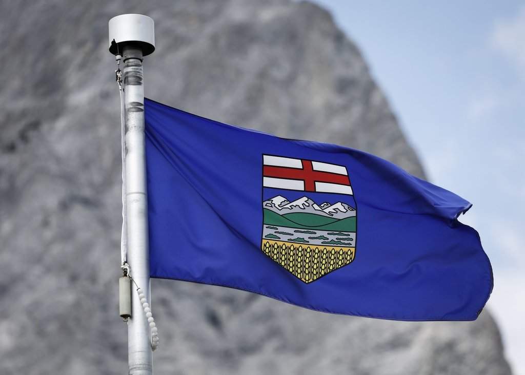 An Alberta flag flaps in the breeze with Mt. Kidd in the background at the site of the G7 Leaders meeting in Kananaskis, Alta., on Monday, June 2, 2025.