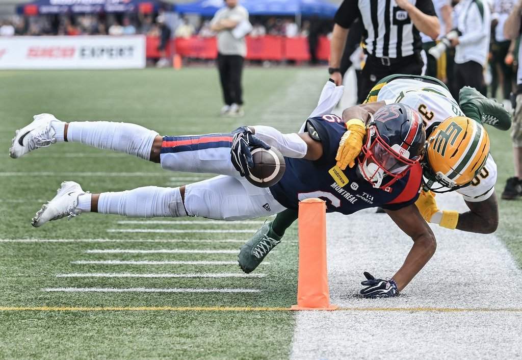 Montreal Alouettes' Tyson Philpot (6) scores a touchdown as he's being tackled by Edmonton Elks' Tyrell Ford (30) during first half CFL football action in Montreal, on Saturday, Aug. 8, 2026. THE CANADIAN PRESS/Graham Hughes.