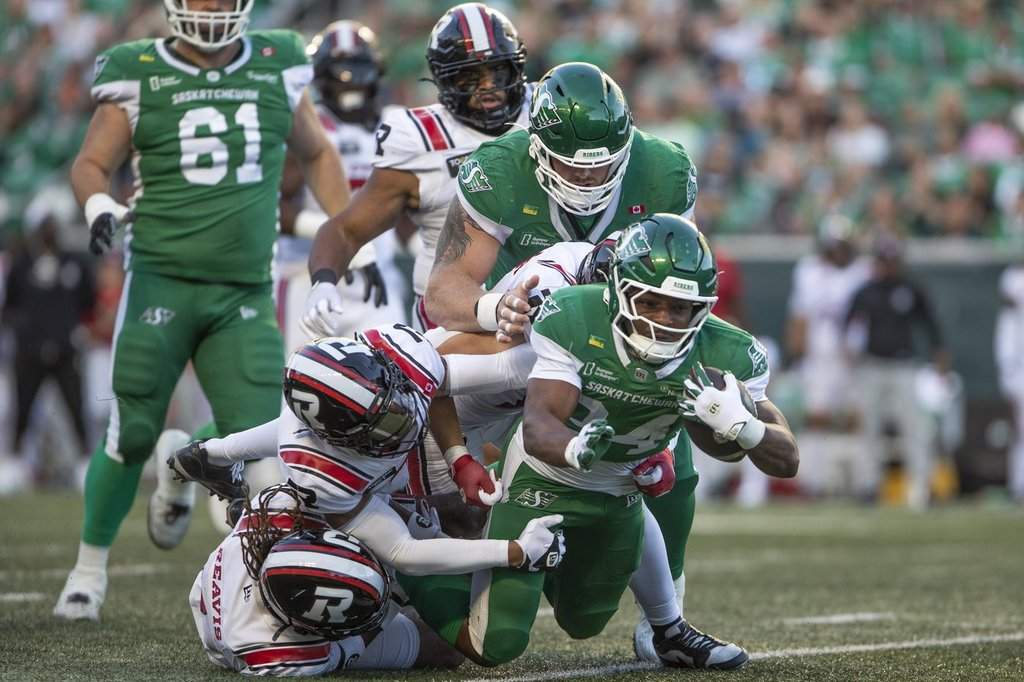 Saskatchewan Roughriders running back Quali Conley (24) is tackled by the Ottawa Redblacks defence during first half CFL football action in Regina on Friday, Aug. 7, 2026. THE CANADIAN PRESS/Kayle Neis.