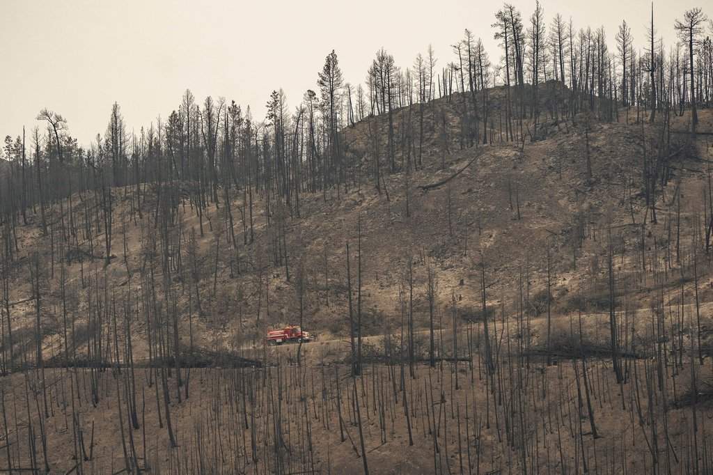 A fire truck is seen on a hillside burned by the Bald Range wildfire, in this handout photo, near Summerland, B.C., on Monday, Aug. 17, 2026. THE CANADIAN PRESS/Handout — Regional District of Okanagan-Similkameen (Mandatory Credit).