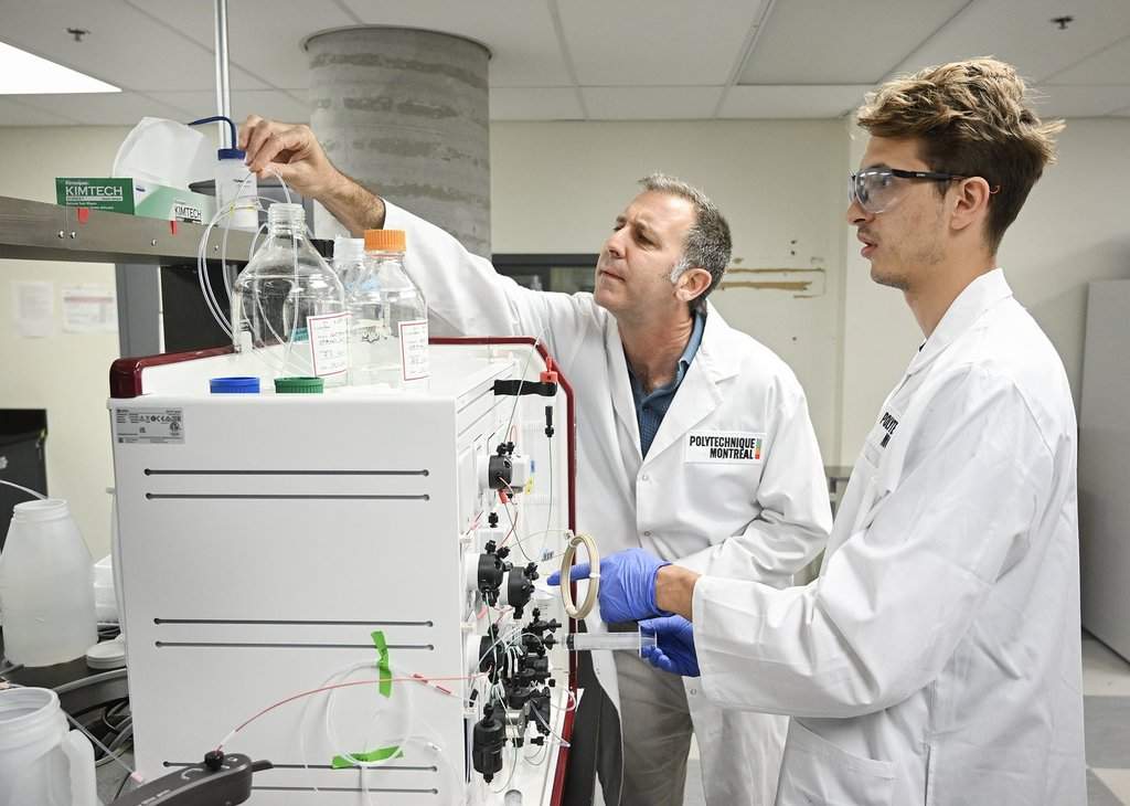 Gregory de Crescenzo, full professor in Polytechnique Montreal's Department of Chemical Engineering, left, and PhD student Benjamin Serafin demonstrate the protein purification process in the pandemic preparedness lab, in Montreal, on Wednesday, June 17, 2026. THE CANADIAN PRESS/Graham Hughes.