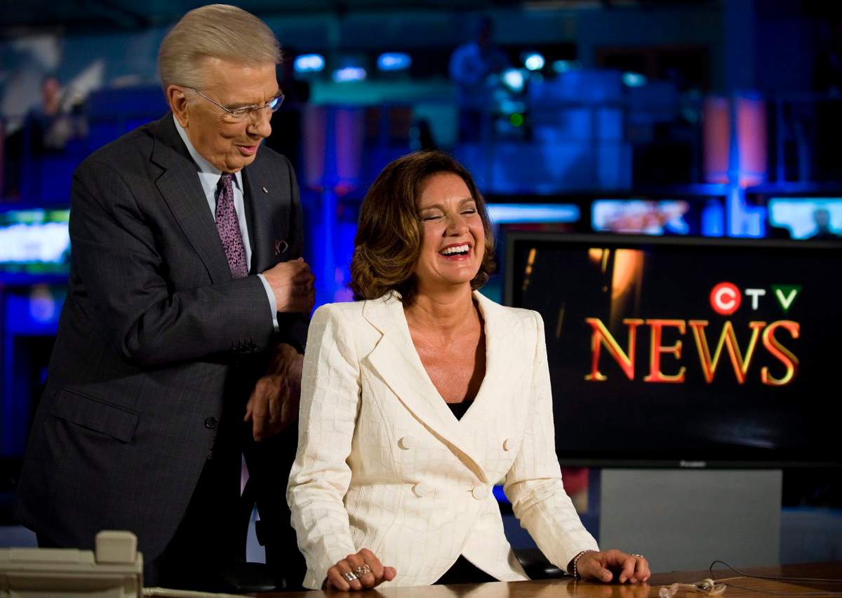Lisa LaFlamme (right) sits in the anchor’s chair as CTV announces that she will succeed Lloyd Robertson (left) as anchor of CTV News, in Toronto on Friday, July 9, 2010.