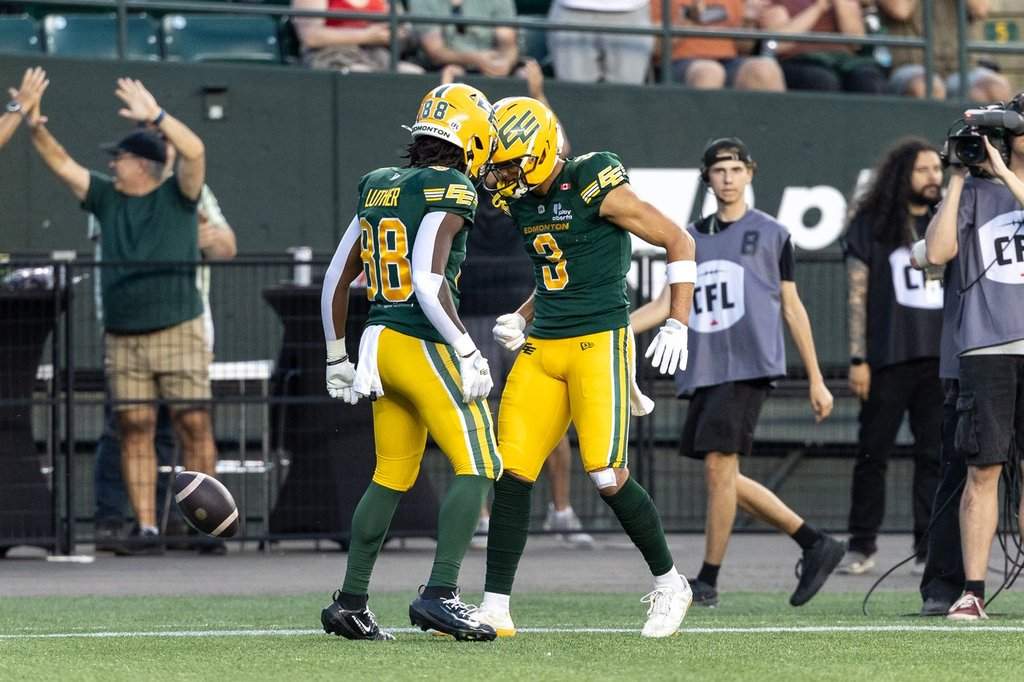 Edmonton Elks' Austin Mack (3) celebrates his touchdown against the Winnipeg Blue Bombers with teammate TJ Luther (88) during first half CFL action in Edmonton on Friday, August 21, 2026. THE CANADIAN PRESS/Timothy Matwey.