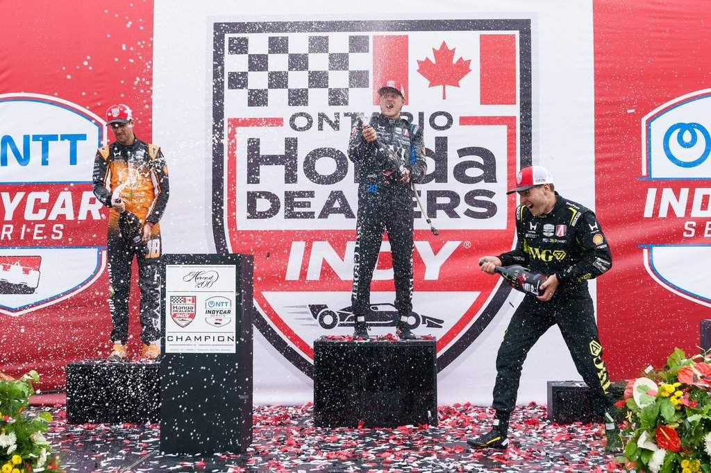 Marcus Ericsson, of Sweden, centre, celebrates after winning the 2026 Honda Indy with second-place Romain Grosjean, of Switzerland, left, and third-place Will Power, of Australia in Markham, Ont. on Sunday, Aug. 16, 2026. 