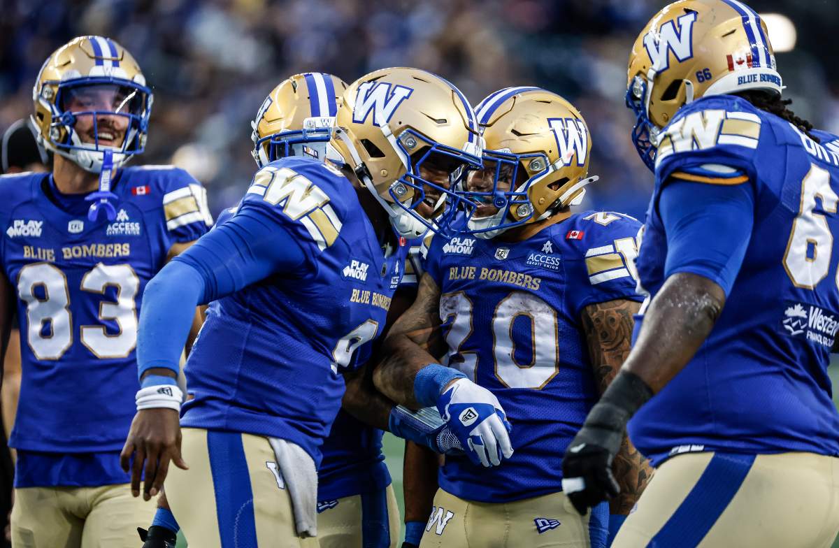 Winnipeg Blue Bombers quarterback Bryce Perkins (9) and Brady Oliveira (20) celebrate PerkinsÕ touchdown against the Ottawa Redblacks during first half CFL football action in Winnipeg on Friday, August 14, 2026. THE CANADIAN PRESS/John Woods.