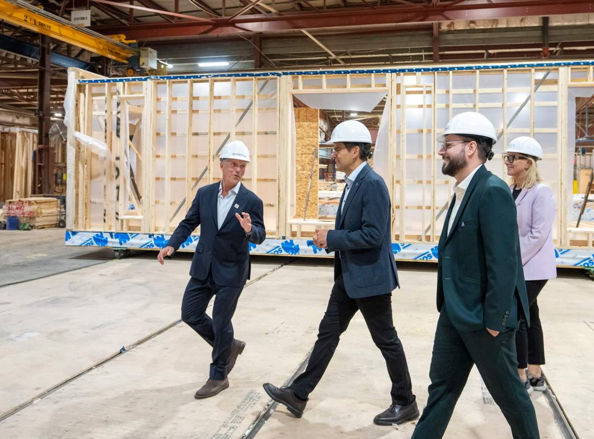 Quebec Liberal Party Leader Charles Milliard, centre, tours Bonneville Industries, a modular home builder with co-president Eric Bonneville, left, during a campaign stop in Beloeil, Que., on Monday, Aug. 31, 2026. Quebec votes in a provincial election on Oct. 5, 2026.