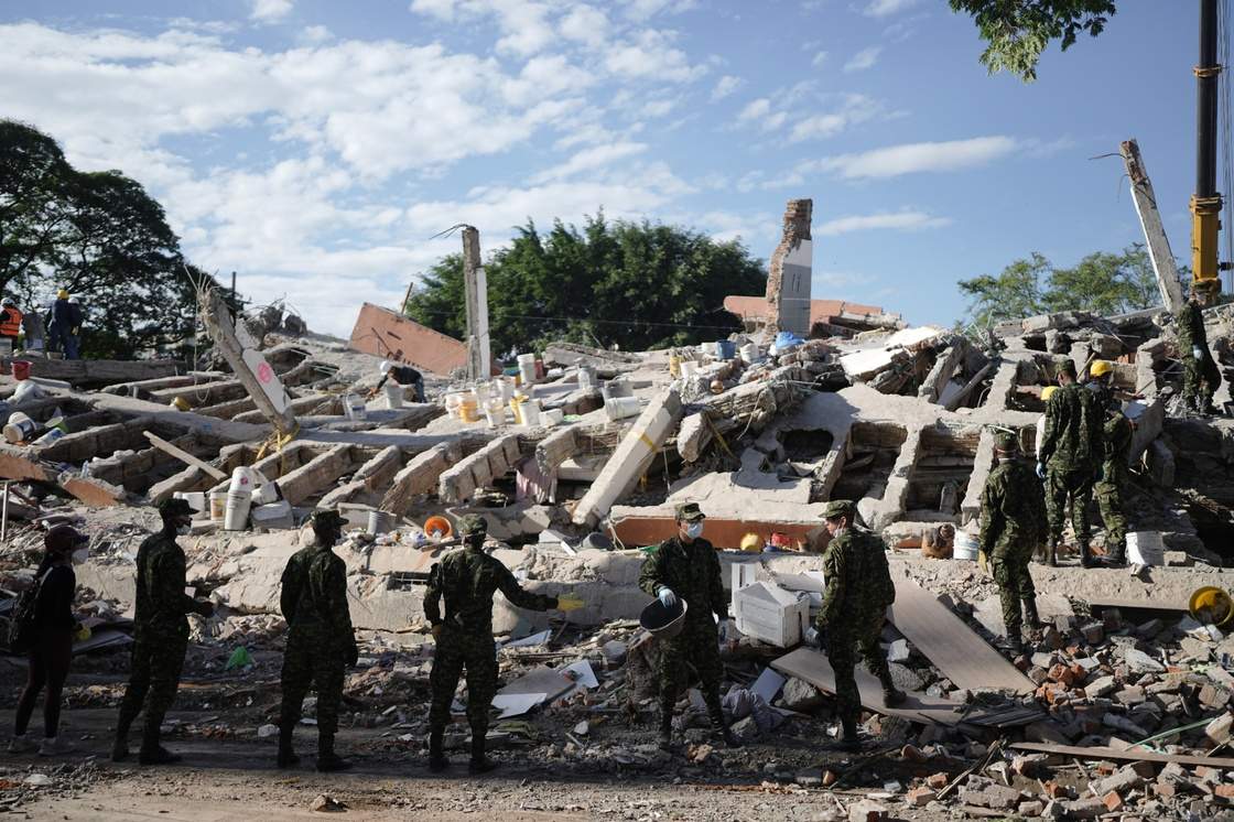 Soldiers clear debris three days after an earthquake struck Cali, Colombia, Thursday, Aug. 13, 2026. (AP Photo/Ivan Valencia)