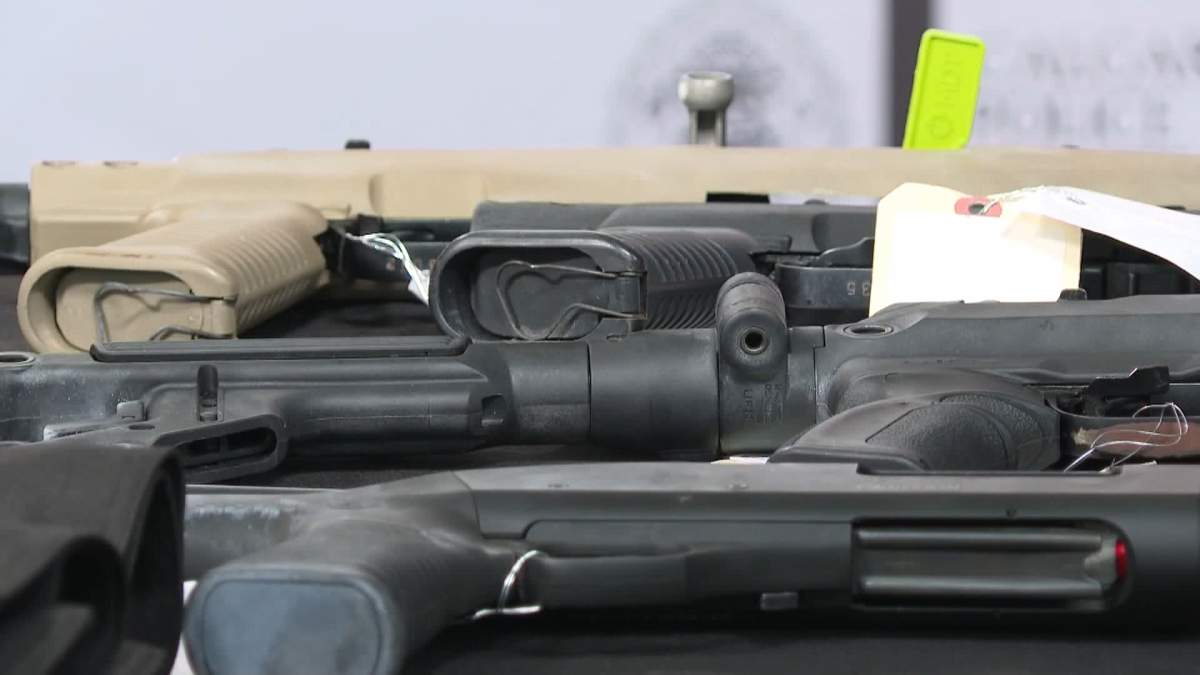 Calgary police display several of the guns seized during the investigation into organized crime and drug trafficking.