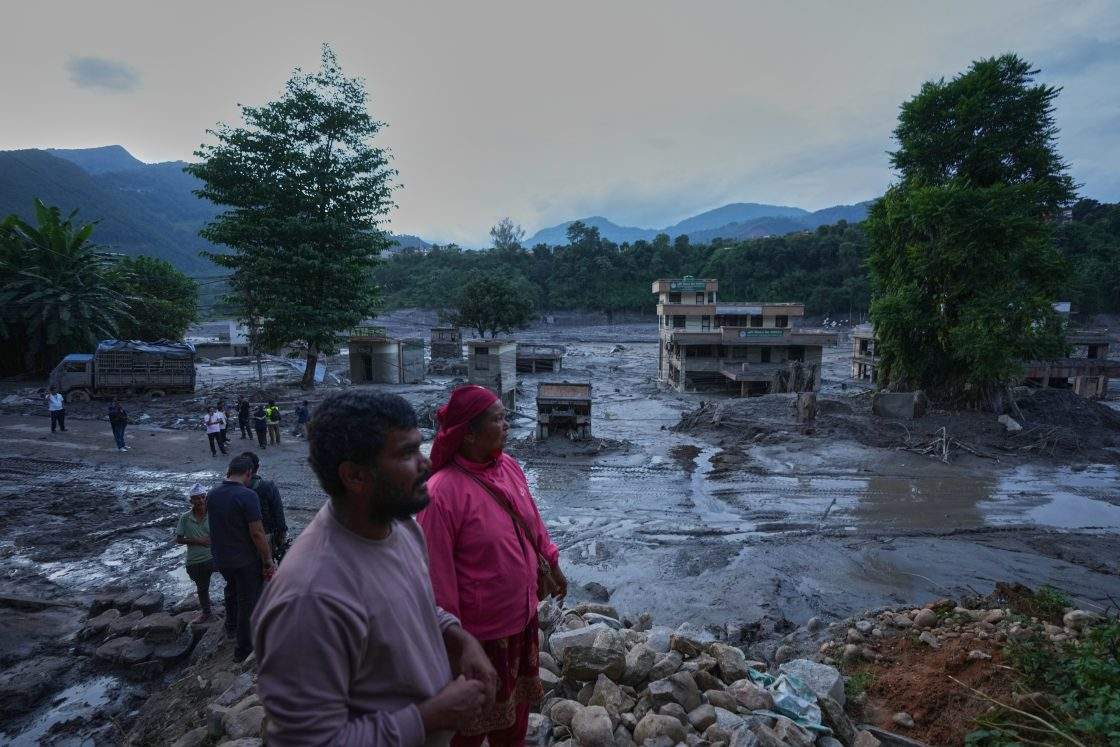 Residents look at the devastation left by flash flooding in Nepal’s Nuwakot district, Thursday, Aug. 27, 2026.