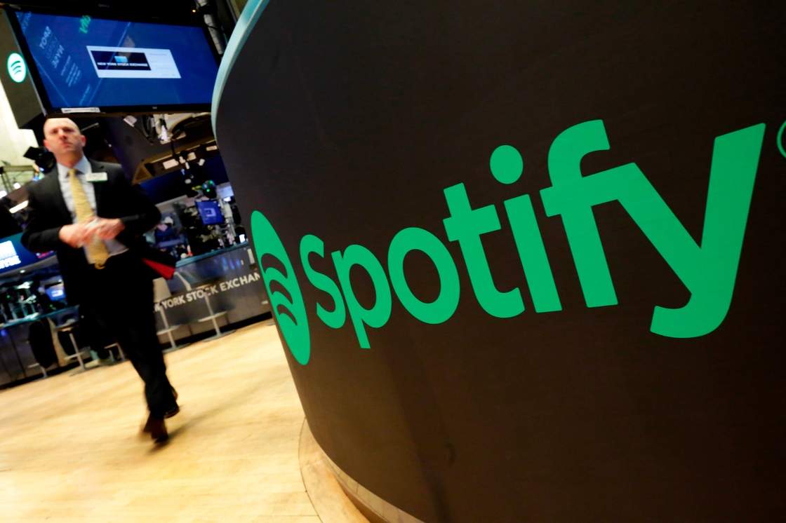 FILE - A trading post sports the Spotify logo on the floor of the New York Stock Exchange, Tuesday, April 3, 2018. (AP Photo/Richard Drew, File)